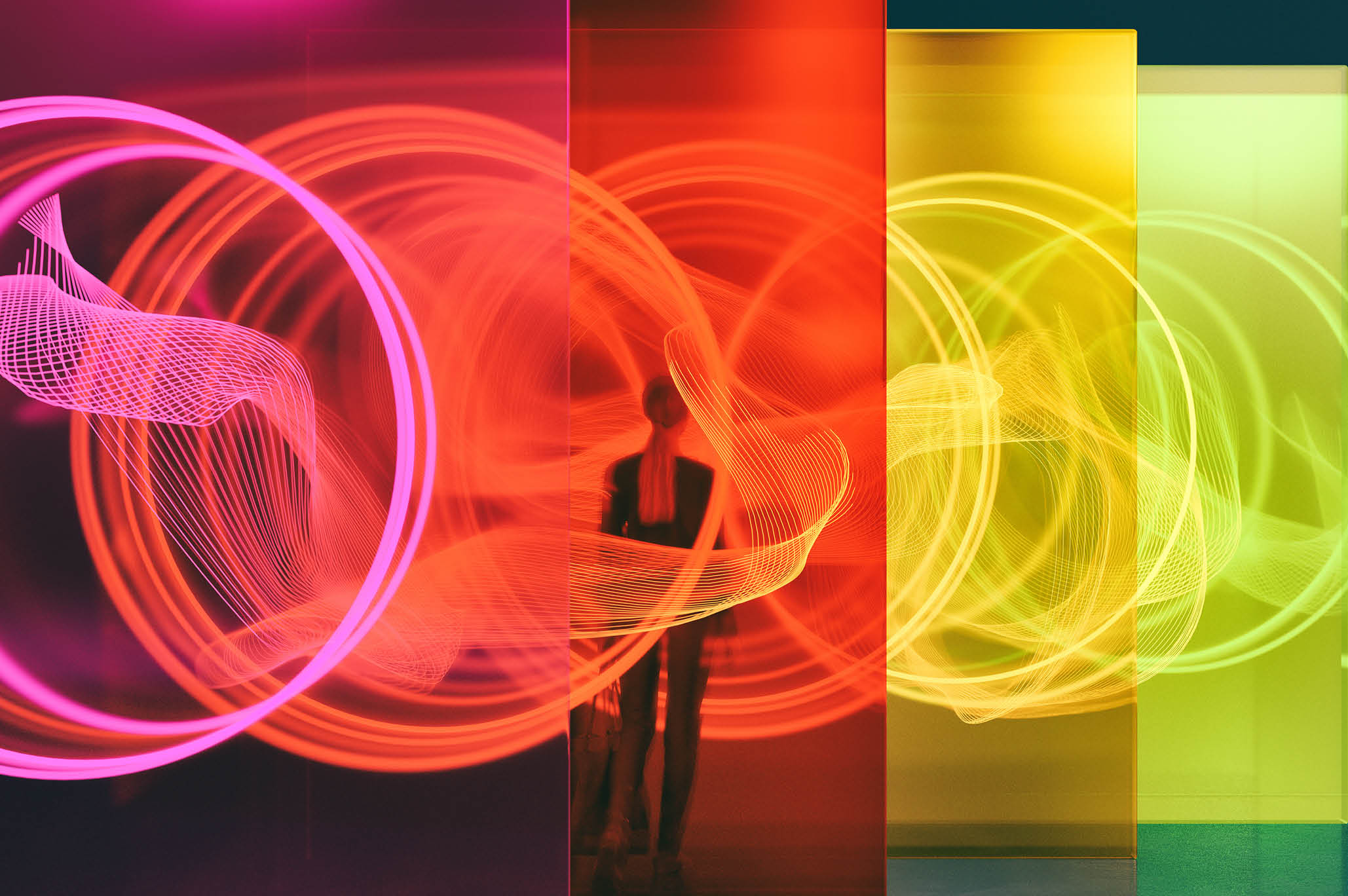 A person standing among glass walls illuminated by glowing rings. All objects in the scene are 3D