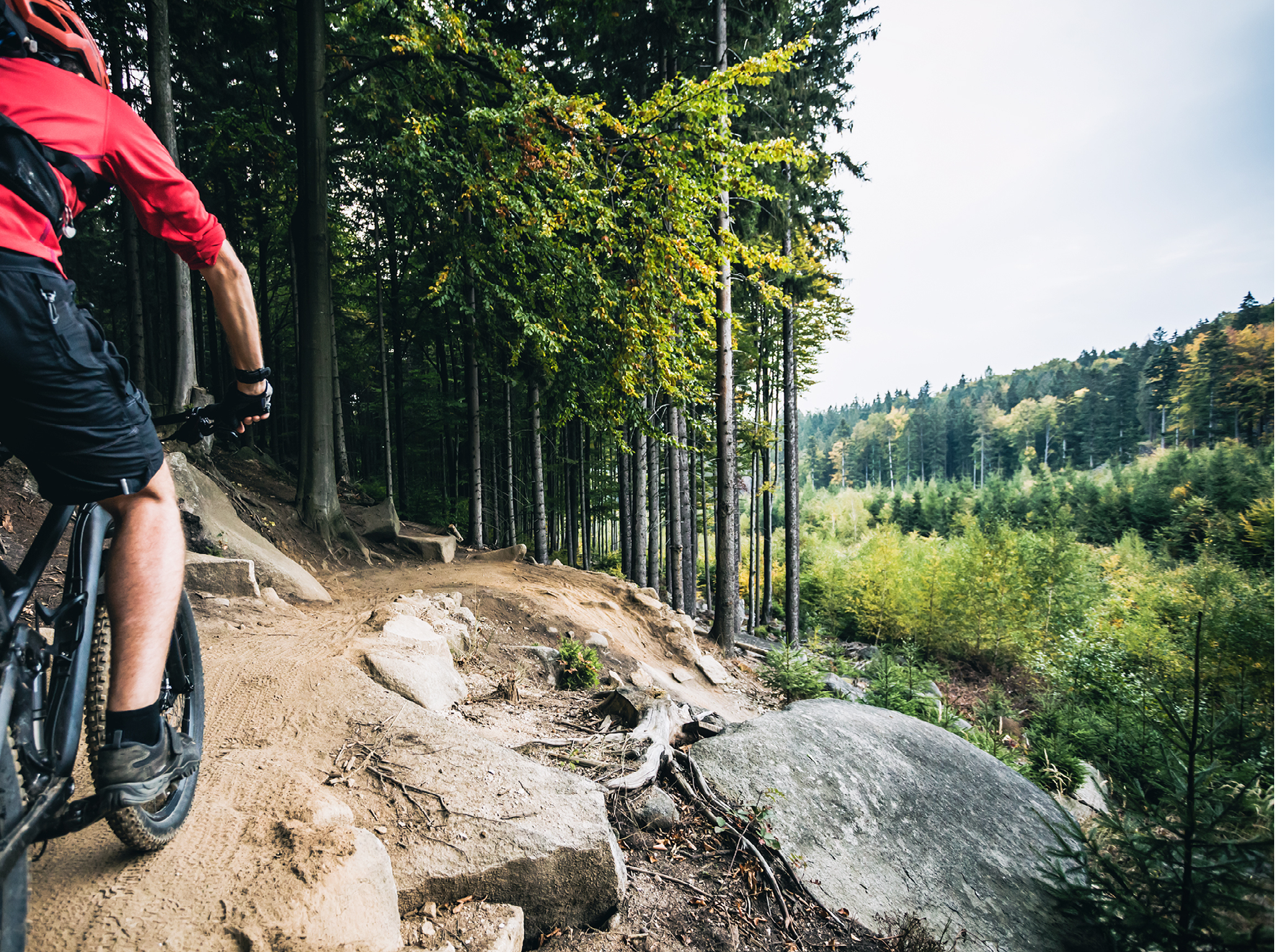 Mountain biker riding on bike in autumn inspirational mountains landscape. Man cycling MTB on enduro trail track. Sport fitness motivation and inspiration.