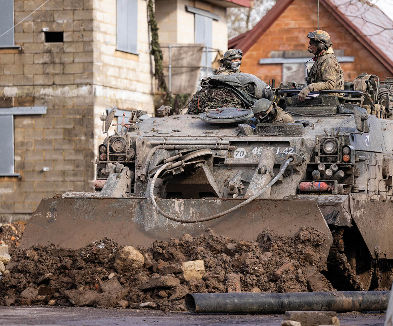 Pictured: The Challenger Armoured Repair and Recovery Vehicle (CRARRV) using its bulldozer blade to clear debris. The Combat Manoeuvre Centre provides combat and Combined Arms Manoeuvre (CAM) individual training, from initial training to sub-unit, Battle Group commanders and, in time, formation staff (Brigade and Division staff).   Comprising of units formerly known as the Specialist Weapons School and the Reconnaissance and Armoured Tactics Division, the Combined Arms Manoeuvre School (CAMS) is based at Warminster and delivers agile and adaptable specialist weapons training to Officers and Soldiers of the Field Army.  The Challenger Armoured Repair and Recovery Vehicle (CRARRV) is a highly evolved armoured vehicle designed to recover and repair damaged tanks on the battlefield.  The vehicle has two winches, main and auxiliary, and an Atlas hydraulically operated crane capable of lifting a complete Challenger 2 power pack.  Based on the Challenger 1 chassis and is designed to recover and repair damaged or incapacitated Challenger 2 tanks, but is also powerful enough to recover other heavy armoured vehicles such as the AS-90.  Operated by 'Recovery Mechanics' from the Royal Electrical and Mechanical Engineers.