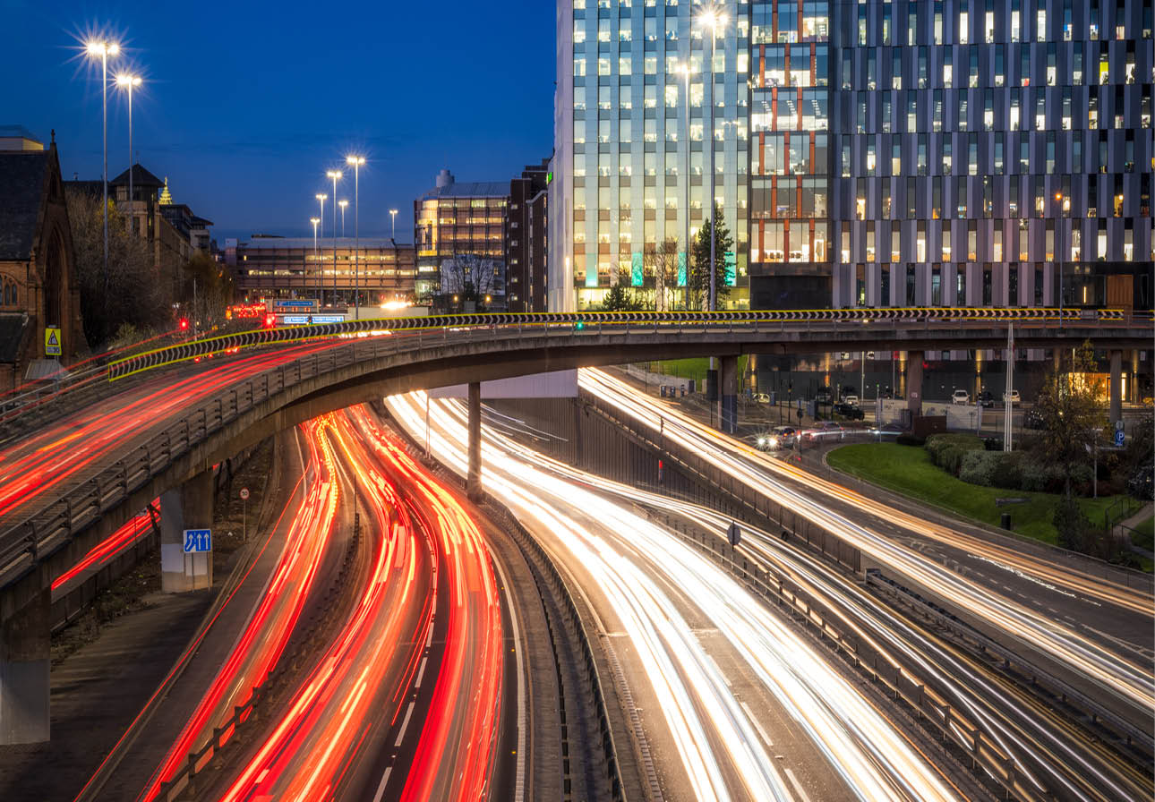 A long exposure of rush hour evening traffic on the M8 motorway and connecting roads at Charing Cross in Glasgow, Scotland.