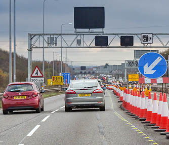 Bristol, England, UK - 29 November 2023: Traffic driving through roadworks on the M4 motorway near Bristol