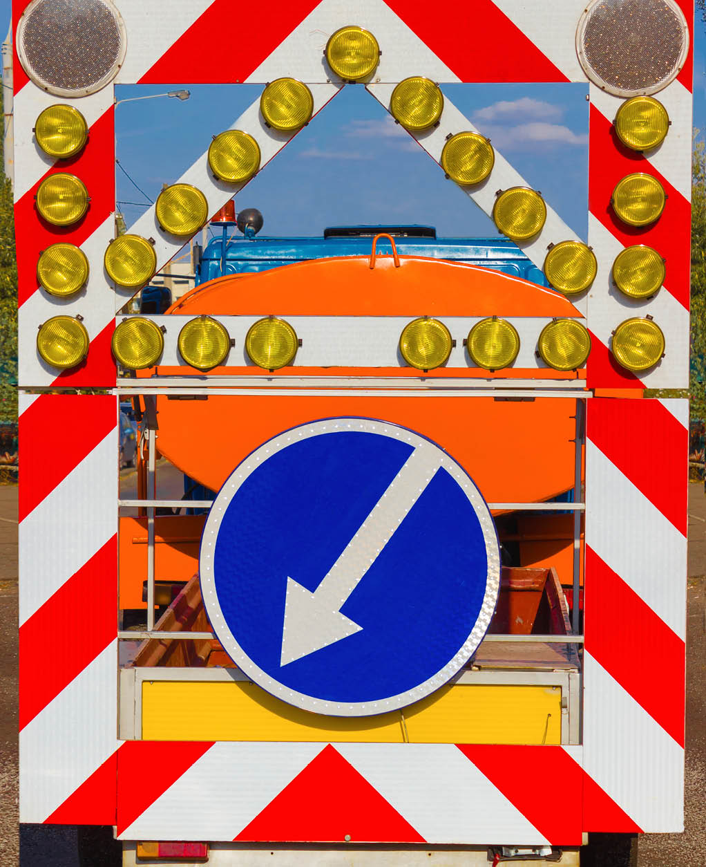 warning sign (detour) and the repair of the road . Municipal road engineering on a Sunny day.